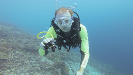 A-diver-takes-a-selfie-against-deep-blue-water