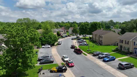 Aerial-flyover-american-neighborhood-with-townhouses-and-parking-cars