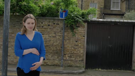 Beautiful-pregnant-woman-walking-down-residential-street-in-London