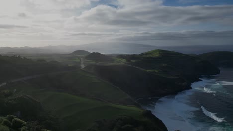 Aerial-view-of-Terceira-from-a-4K-drone,-showcasing-lush-green-fields-and-the-expansive-sea