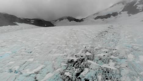 A-lone-adventurer-crosses-the-Brewster-Glacier,-navigating-the-icy-expanse-amidst-the-majestic-peaks-of-New-Zealand's-Southern-Alps