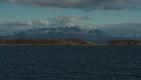 Seagulls-flock-overfly-ocean-with-ice-mountains-in-background-in-Ushuaia-Argentina-Patagonia