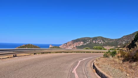 Highway-travelling,-point-of-view,-Sardinian-picturesque-coastline