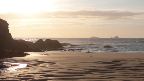 Scenic-golden-hour-aerial-over-Treyarnon-Beach-on-Cornwall-coastline,-UK