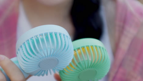 couple-of-mini-electric-battery-fan-for-cooling-down-and-refreshing-during-summer-heat-waves