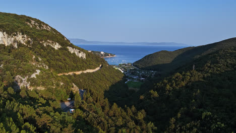 Aerial-shot-in-middle-mountains,-overlooking-the-Rabac-resort,-in-Istria,-Croatia