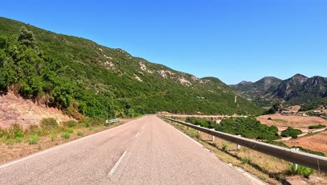 Winding-ribbons-of-asphalt-cling-to-hilly-terrain,-safety-road-barriers