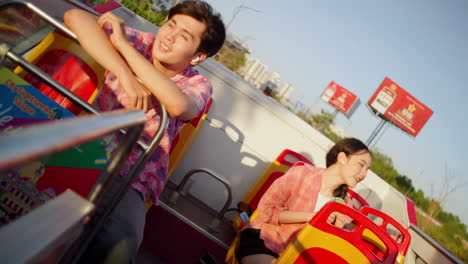 couple-travelling-on-open-tour-bus-during-hot-summer-day