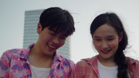 close-up-portrait-of-young-couple-smiling-while-making-soap-bubble-during-a-summer-day