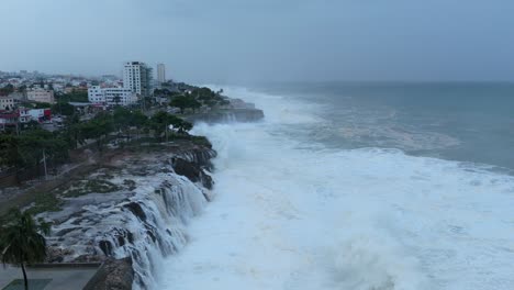 Large-wave-break-at-rocky-coastline-Caribbean-island,-tropical-storm,-hurricane