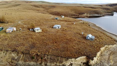 Flyby-of-remote-fishing-cribs-on-lake-Onslow-in-the-dramatic-landscapes-of-Central-Otago