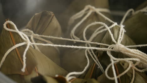 Cooking-zongzi-food---preparing-and-steaming-Chinese-rice-dumpling.