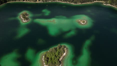 Eibsee-Bayern-Germany-aerial-view-overhead-view-of-the-beautiful-lake-and-shallow-but-colourful-water