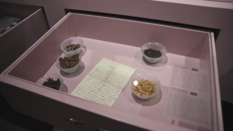 Handwritten-recipe-and-various-ingredients-displayed-in-a-drawer-at-the-Zagreb-Chocolate-Museum