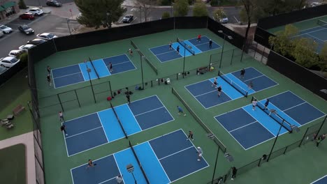 Aerial-view-of-multiple-players-in-action-on-pickleball-courts