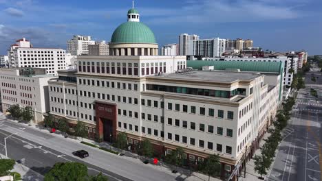 Ayuntamiento-De-West-Palm-Beach,-Cúpula-Verde-Distintiva,-Modernos-Edificios-De-Gran-Altura-Y-Calles-Bulliciosas-Que-Muestran-El-Paisaje-Urbano.