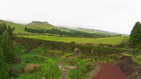 Aerial-zoom-out-at-Muro-das-Nove-Janelas-green-aqueduct-wall-in-Azores-Portugal