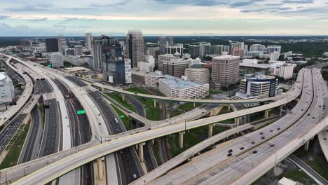 Downtown-Orlando,-Florida-with-an-extensive-network-of-highways-and-overpasses-with-the-city-skyline-in-the-background