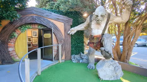 Exterior-view-of-Weta-Cave-and-Workshop-entrance-with-hobbit-door-and-troll-from-Lord-of-the-Rings-in-Wellington,-New-Zealand-Aotearoa