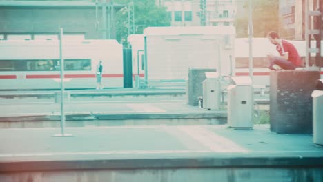 A-POV-perspective-from-inside-a-moving-train,-capturing-an-Arab-family,-passengers,-and-the-platform