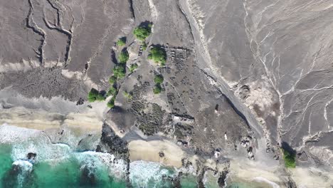 Top-Down-Aerial-View,-Beach-and-Barren-Landscape-of-Volcanic-Island,-Santa-Luzia,-Cape-Verde-60fps