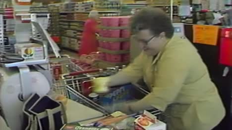 1970s-GROCERY-STORE-CLERK-SORTING-FOOD-ITEMS