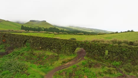 Aerial-drone-reveals-green-wall-aqueduct-of-Portugal-Azores,-Travel-landscape