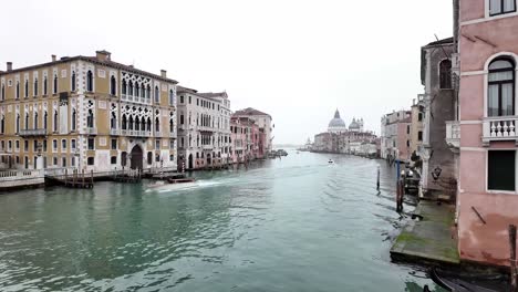 Boats-passing-by-on-a-water-canal-in-the-city-of-Venice