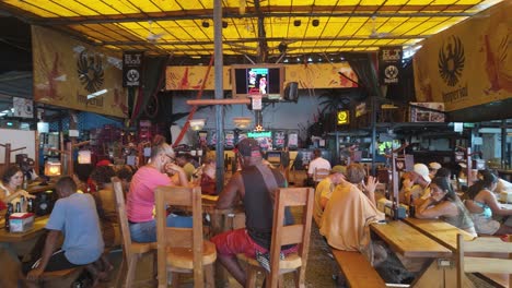 Panoramic-view-of-the-Hot-Rocks-Caribbean-restaurant-with-local-people-play-bingo-game-in-Puerto-Viejo,-Costa-Rica