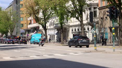 Traffic-on-sunny-street-Sveavägen-in-Stockholm,-Sweden-in-summer