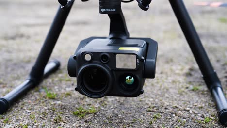 Close-up-of-large-industrial-drone-camera-rotate-while-turn-on-aircraft