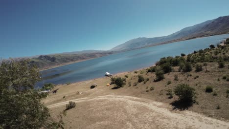 FPV-drone-view-of-tourist-complex-with-two-luxury-glamping-domes-on-La-Angostura-dam