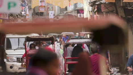 Street-scene-of-traffic-on-small-street-in-Old-Delhi,-India