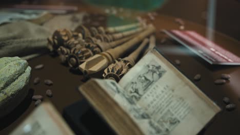 Open-antique-book-on-chocolate-with-cocoa-pods-and-historical-items-on-display-at-the-Zagreb-Chocolate-Museum