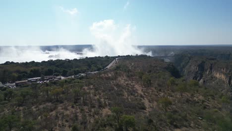 Aerial-Drone-View-of-Victoria-Falls-and-the-Rainbows,-In-Between-Zambia-and-Zimbabwe