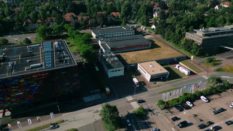 Aerial-view-of-Beeld-en-Geluid-and-the-media-studio-complex-at-Media-Park-in-Hilversum,-showcasing-the-colorful-facade-and-surrounding-broadcasting-facilities