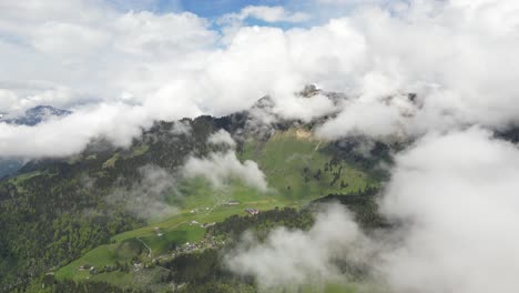 Fronalpstock-Glarus-Switzerland-aerial-above-the-clouds-looking-at-village