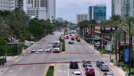 American-highway-with-traffic-with-palm-trees-in-Sunny-Isles-Beach-Town,-Florida