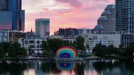 Downtown-Orlando,-Florida,-with-iconic-Lake-Eola-rainbow-amphitheater-at-sunset-with-skyscrapers-in-the-background