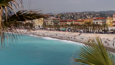 Crowd-On-Beach-By-Quai-des-Etats-Unis-On-Promenade-des-Anglais-In-Nice,-France,-Wide-Shot