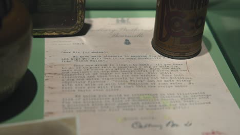 Close-up-of-a-vintage-letter-and-cocoa-tin-on-display-at-the-Zagreb-Chocolate-Museum