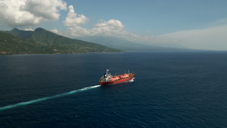 Red-crude-oil-tanker-cruise-in-ocean-near-Bali-North-Coast,-aerial-view