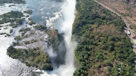 Aerial-Drone-View-of-Victoria-Falls-and-the-Rainbows,-In-Between-Zambia-and-Zimbabwe