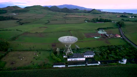 Aerial-shot-of-an-abandoned-communication-satellite-surrounded-by-beautiful-scenic-greenery-and-mountains-in-São-Miguel-Island