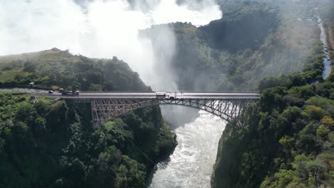 Aerial-Drone-View-Of-Victoria-Falls-And-Its-Bridge,-In-Between-Zambia-And-Zimbabwe