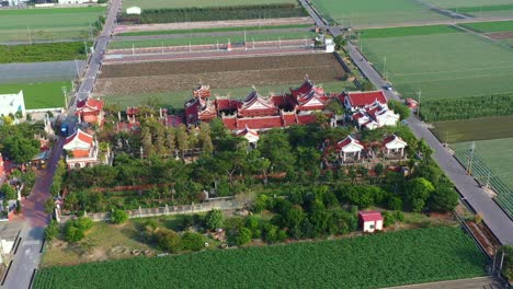 Aerial-drone-flyover-and-around-Chifa-Matsu-Temple-Complex-in-the-middle-of-agricultural-fields,-a-sacred-site-dedicated-to-goddess-of-sea,-a-blend-of-cultural-heritage-and-rural-landscape-in-Taiwan