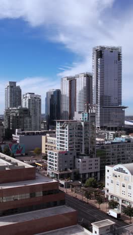 Vertical-Drone-Shot,-Downtown-Los-Angeles,-Graffiti-Towers-and-Buildings-Around-Crypto