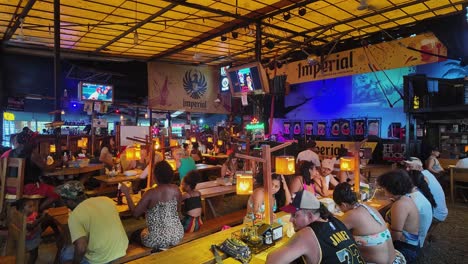 Costa-Rican-people-socialize-and-are-entertained-by-the-bingo-game-at-night-in-a-colorful-and-illuminated-bar-in-Puerto-Viejo