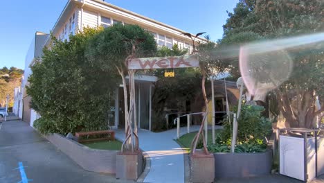 Exterior-view-of-Weta-Cave-and-film-production-workshop-building-with-welcome-sign-in-Miramar,-Wellington,-New-Zealand-Aotearoa