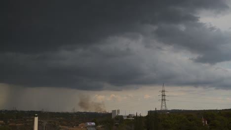 Medium-static-shot-of-forest-fire-due-to-lightning-strikes-at-forest-amongst-Parnithe-and-Penteli-mountains,-Greece-4K